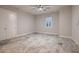 Spacious bedroom featuring tile flooring, a modern ceiling fan, and a window with plantation shutters at 7966 W Ford Ave, Las Vegas, NV 89113