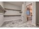 Walk in closet providing ample storage for clothing and accessories with easy access to the ensuite bathroom at 7966 W Ford Ave, Las Vegas, NV 89113