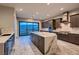Beautiful kitchen with stainless steel appliances, center island, and sliding glass doors to backyard pool at 7966 W Ford Ave, Las Vegas, NV 89113