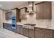 Well-equipped kitchen with stainless steel appliances, stylish cabinets, and stone countertops at 7966 W Ford Ave, Las Vegas, NV 89113