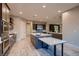Modern kitchen featuring stainless appliances, large island with counter seating and tile flooring at 7966 W Ford Ave, Las Vegas, NV 89113