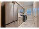 Contemporary laundry room with modern appliances, ample storage cabinets, and tile flooring at 7966 W Ford Ave, Las Vegas, NV 89113