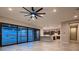 Open living space with modern lighting, kitchen access, and sliding glass doors to the pool area at 7966 W Ford Ave, Las Vegas, NV 89113