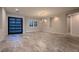 Bright open floorplan with recessed lighting, stylish light fixture, and large format tile flooring at 7966 W Ford Ave, Las Vegas, NV 89113