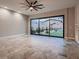 Sunlit living room with sliding glass doors that provide beautiful views of the landscaped backyard at 7966 W Ford Ave, Las Vegas, NV 89113