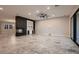 Open concept living room boasts a modern fireplace, built-in bar, and large sliding glass door at 7966 W Ford Ave, Las Vegas, NV 89113