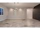 Open floorplan with recessed lighting, stylish light fixture, large format tile flooring and a modern design at 7966 W Ford Ave, Las Vegas, NV 89113