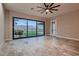 A bright, spacious living room with large sliding glass doors opening to a pristine backyard with a pool at 7966 W Ford Ave, Las Vegas, NV 89113