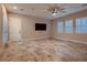 Well-lit living area with modern ceiling fan, multiple windows with shutters, and neutral walls at 7966 W Ford Ave, Las Vegas, NV 89113
