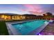 Backyard with a sparkling pool, lawn, and covered patio perfect for entertaining at 7966 W Ford Ave, Las Vegas, NV 89113