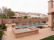 Gorgeous pool and spa area with brick accents and steps at 8070 Pavarotti Ave, Las Vegas, NV 89178