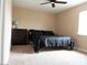 Comfortable bedroom featuring a black bed frame, a dark wood dresser, and ample natural light at 8070 Pavarotti Ave, Las Vegas, NV 89178