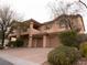 Charming two-story home featuring a three-car garage and landscaped front yard at 8070 Pavarotti Ave, Las Vegas, NV 89178