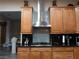 Close up of the kitchen with wooden cabinets and stainless steel hood at 8070 Pavarotti Ave, Las Vegas, NV 89178