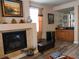 Living room featuring a fireplace, wet bar, warm neutral paint, and dark laminate floors at 8070 Pavarotti Ave, Las Vegas, NV 89178