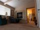 Cozy living room featuring a fireplace, comfortable seating, and an open doorway leading to the bathroom at 8070 Pavarotti Ave, Las Vegas, NV 89178