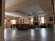 Open-concept living area with dark laminate flooring, a fireplace, and plenty of natural light at 8070 Pavarotti Ave, Las Vegas, NV 89178