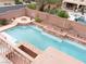 Aerial view of a stunning pool area complete with a fire pit and lush landscaping at 8070 Pavarotti Ave, Las Vegas, NV 89178
