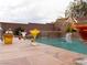 Poolside bar featuring an array of colorful cocktails against a brick waterfall backdrop at 8070 Pavarotti Ave, Las Vegas, NV 89178