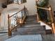 Staircase with decorative iron and wood railings and laminate floors. The stairway is spacious and open at 8070 Pavarotti Ave, Las Vegas, NV 89178