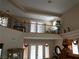 Upstairs loft featuring decorative iron railings, neutral carpet, and French doors for privacy at 8070 Pavarotti Ave, Las Vegas, NV 89178