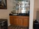 The wet bar features plenty of storage, dark countertops, a sink, and mirrored glass shelving at 8070 Pavarotti Ave, Las Vegas, NV 89178