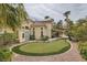 Spacious backyard with a putting green, mature landscaping, and a covered patio at 8324 Slate Harbor Cir, Las Vegas, NV 89128
