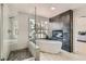 Modern bathroom with freestanding tub, glass shower, and unique accent wall feature at 8324 Slate Harbor Cir, Las Vegas, NV 89128