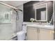 Modern bathroom with updated fixtures, patterned accent wall, a walk-in shower with glass door at 8324 Slate Harbor Cir, Las Vegas, NV 89128