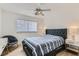 Modern bedroom featuring a tufted headboard, stylish nightstands, and a ceiling fan at 8324 Slate Harbor Cir, Las Vegas, NV 89128