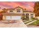 Charming two-story home featuring a tile roof, desert landscaping, and an attached two-car garage at 8324 Slate Harbor Cir, Las Vegas, NV 89128