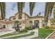 Charming two-story home boasts a tile roof, three-car garage, and well-maintained front yard with mature landscaping at 8324 Slate Harbor Cir, Las Vegas, NV 89128
