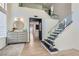 Elegant foyer features a modern staircase, light wood floors, and designer decor at 8324 Slate Harbor Cir, Las Vegas, NV 89128