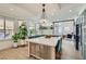 Modern kitchen with a large island, green cabinets, stainless appliances and pendant lighting at 8324 Slate Harbor Cir, Las Vegas, NV 89128