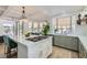 Modern kitchen with a large island, green cabinets, and stainless steel appliances at 8324 Slate Harbor Cir, Las Vegas, NV 89128