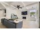 Bright living room boasts a fireplace, coffered ceiling, modern fan, and lots of natural light at 8324 Slate Harbor Cir, Las Vegas, NV 89128