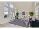 Bright living room features high ceilings, large windows, and neutral decor at 8324 Slate Harbor Cir, Las Vegas, NV 89128