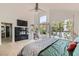 Bright main bedroom features large windows, a fireplace, vaulted ceilings and hardwood floors at 8324 Slate Harbor Cir, Las Vegas, NV 89128