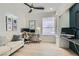 Home office with dual monitors, a comfortable couch, large windows, and lots of natural light at 8324 Slate Harbor Cir, Las Vegas, NV 89128
