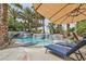 Resort-style pool with a rock waterfall feature and lounge chairs at 8324 Slate Harbor Cir, Las Vegas, NV 89128