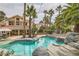 Beautiful pool area with rock features and lush landscaping, perfect for relaxation at 8324 Slate Harbor Cir, Las Vegas, NV 89128