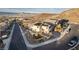 View of the house with a swimming pool and solar panels on the roof, set amidst a scenic mountain backdrop at 864 Firestone Ledge Ave, Henderson, NV 89012