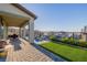Expansive backyard with artificial grass, covered patio, and sleek water feature at 864 Firestone Ledge Ave, Henderson, NV 89012