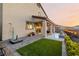 Expansive backyard with artificial grass, covered patio, and sleek water feature at 864 Firestone Ledge Ave, Henderson, NV 89012