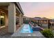 A stunning backyard features a custom water feature, covered patio, and lush landscaping at 864 Firestone Ledge Ave, Henderson, NV 89012
