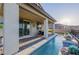 Inviting backyard features a sleek, narrow pool and covered patio, perfect for outdoor relaxation at 864 Firestone Ledge Ave, Henderson, NV 89012