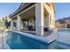 Relaxing backyard features a pool with a covered patio and outdoor seating, perfect for entertaining and enjoying outdoors at 864 Firestone Ledge Ave, Henderson, NV 89012