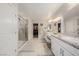 A beautifully designed bathroom with a glass-enclosed shower, double sinks, and access to a walk-in closet at 864 Firestone Ledge Ave, Henderson, NV 89012