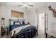 Cozy bedroom featuring an ornate iron bed frame, ceiling fan, and neutral decor at 864 Firestone Ledge Ave, Henderson, NV 89012