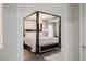 This bedroom boasts a stylish four-poster bed and an elegant chandelier, creating a luxurious retreat at 864 Firestone Ledge Ave, Henderson, NV 89012